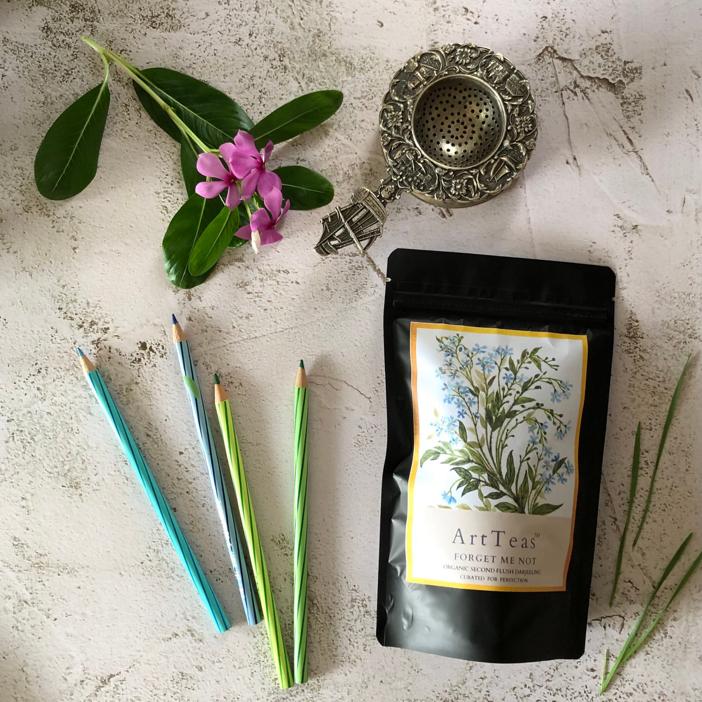 ArtTeas® Organic Second Flush Darjeeling Tea with brewing accessories and Forget Me Not botanical artwork