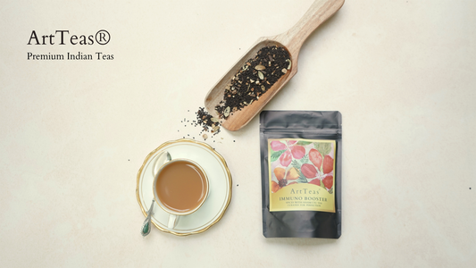 ArtTeas masala chai pouch with loose tea scoop and brewed milky chai in a cup