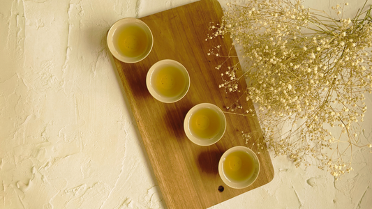 Tea taster evaluating the aroma, liquor, and flavour of freshly brewed tea during a professional tea tasting session.