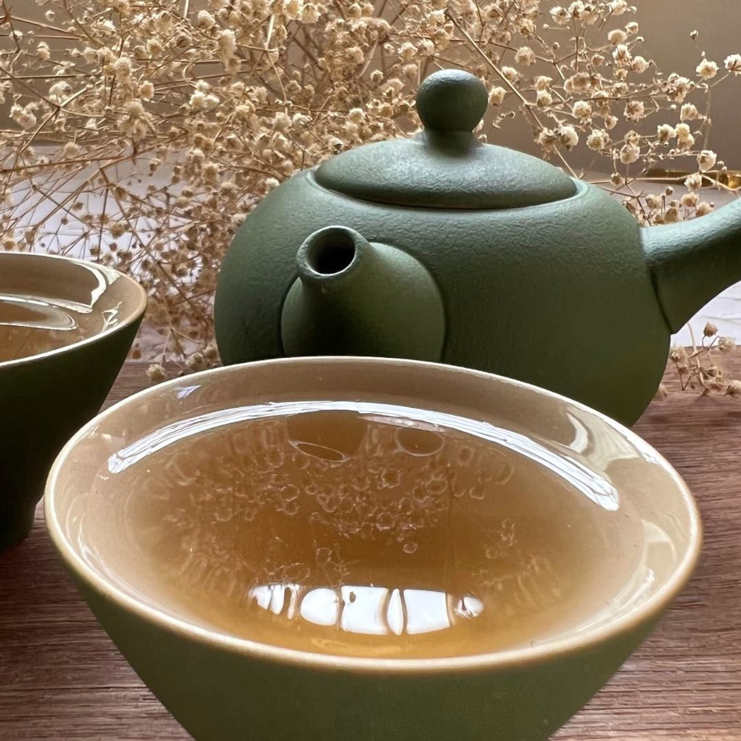Premium loose leaf black tea with bright amber liquor in a ceramic tasting bowl from the ArtTeas Black Tea Collection.