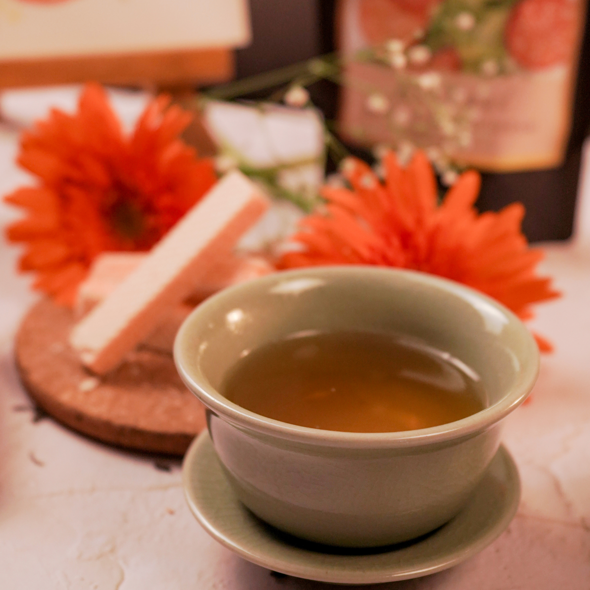 Cup of Blissful Orange Dream green tea with bright citrus aromas and orenge-inspired styling by  ArtTeas®
