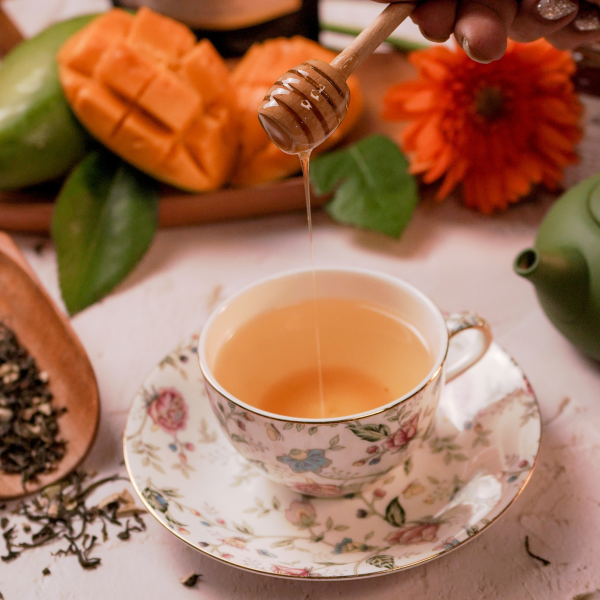 Sun-kissed Mango green tea brewed in vintage china cup - ArtTeas® premiun mango green tea India