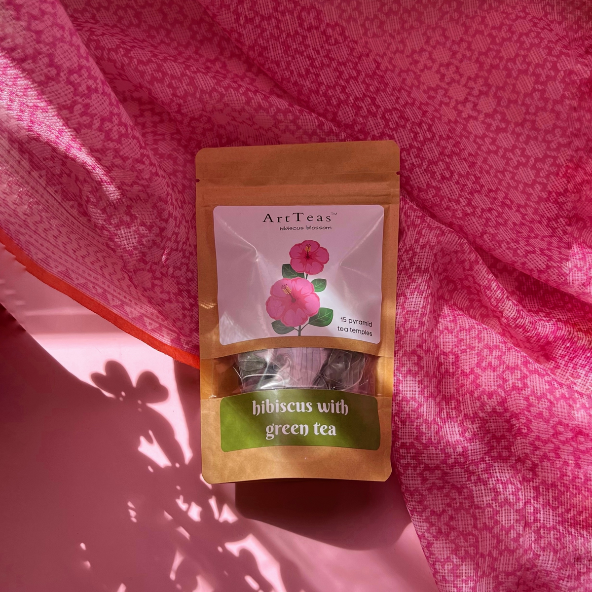 ArtTeas® Green Tea pack displayed on pink fabric background