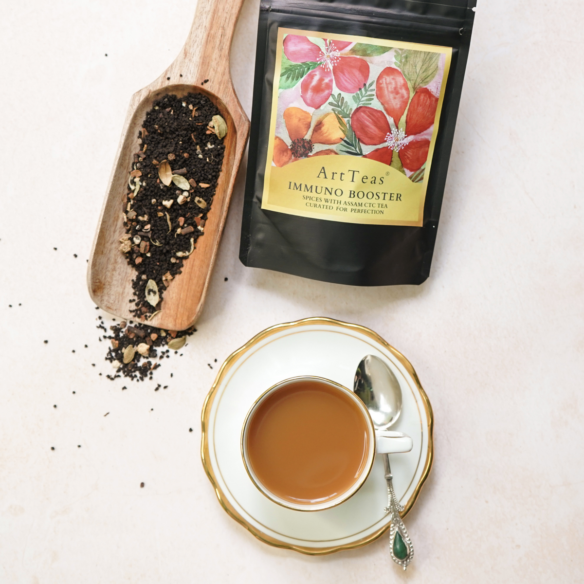 ArtTeas® Assam Masala Chai with loose tea leaves, wooden spoon and premium tea packaging