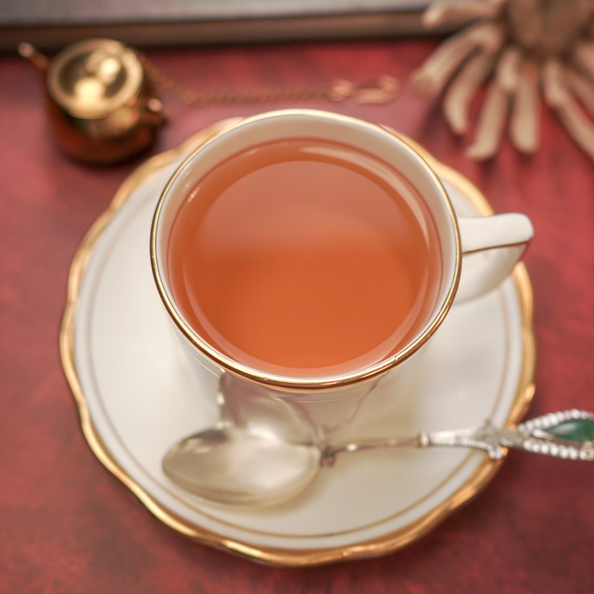 Freshly brewed Hibiscus Nilgiri Green Tea served hot in a glass cup