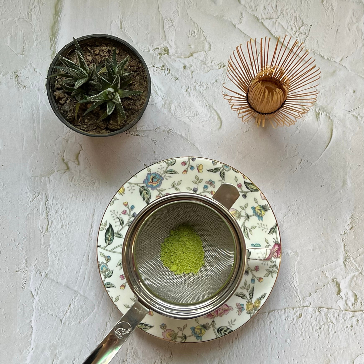Traditional Japanese matcha tea preparation with matcha powder and whisk