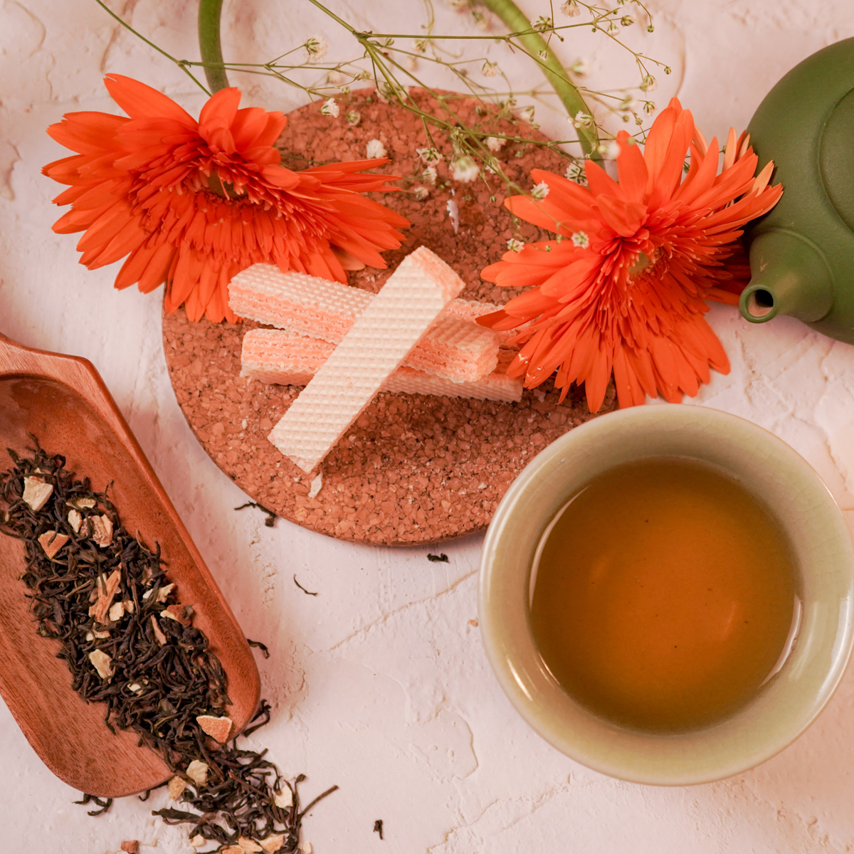  ArtTeas® orange green tea served with loose leaf tea, teacups amd orange floral accents.