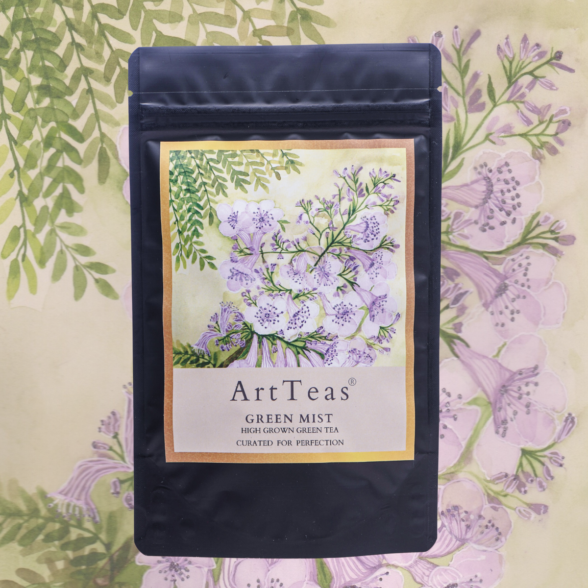 Green Mist green tea packaging featuring original jacaranda watercolor artwork by founder Aarti Khanna.