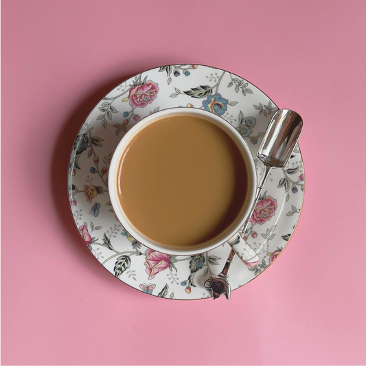 ArtTeas® Silver plated tea measuring spoon beside a cup of loose leaf tea