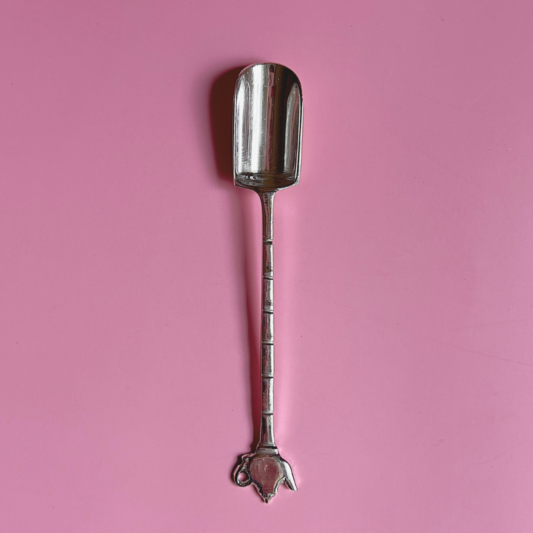 Close-up of silver plated tea measuring spoon with teapot-shaped handle